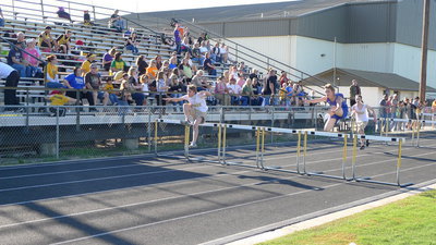 Image: Levi Mcbride soars for a first place finish in the 300m hurdles