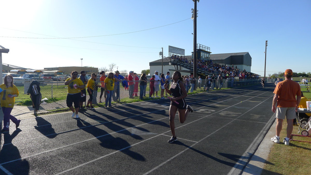 Image: Janae Robertson helps the girls record a first place finish in the relay