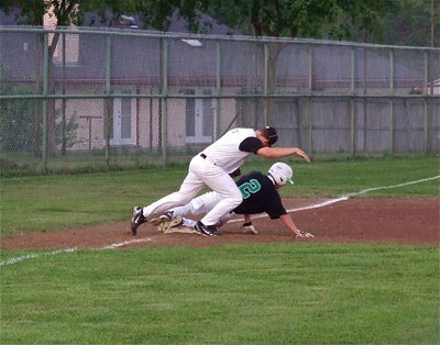 Image: Italy’s third baseman, Kyle Jackson(7), attempts to tag an Eagle runner before he lands but the call goes Rio Vista’s way.