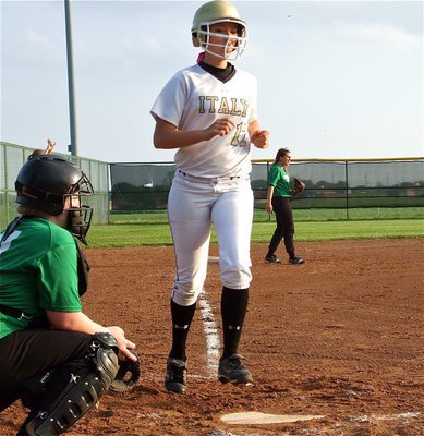 Image: Megan Richards(17) reaches home plate for an Italy score.
