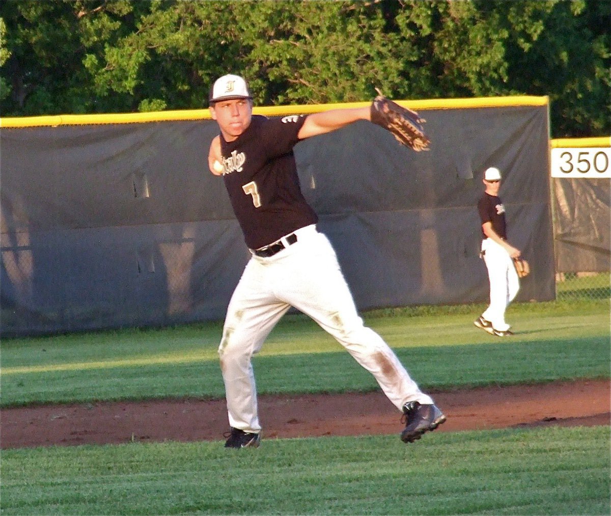 Image: Senior Gladiator third baseman, Kyle Jackson, throws to first base during Italy’s game against Axtell.