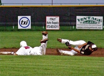 Image: Italy’s, Reid Jacinto(5) a junior, secures the ball from catcher, Ross Stiles, while trying to tag a sliding Axtell runner. 