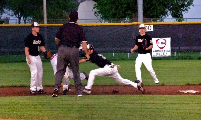 Image: Junior Gladiator shortstop, Caden Jacinto(2) tags a Longhorn during a rundown as Justin Buchanan(13), and Chase Hamilton(10) backup the play.