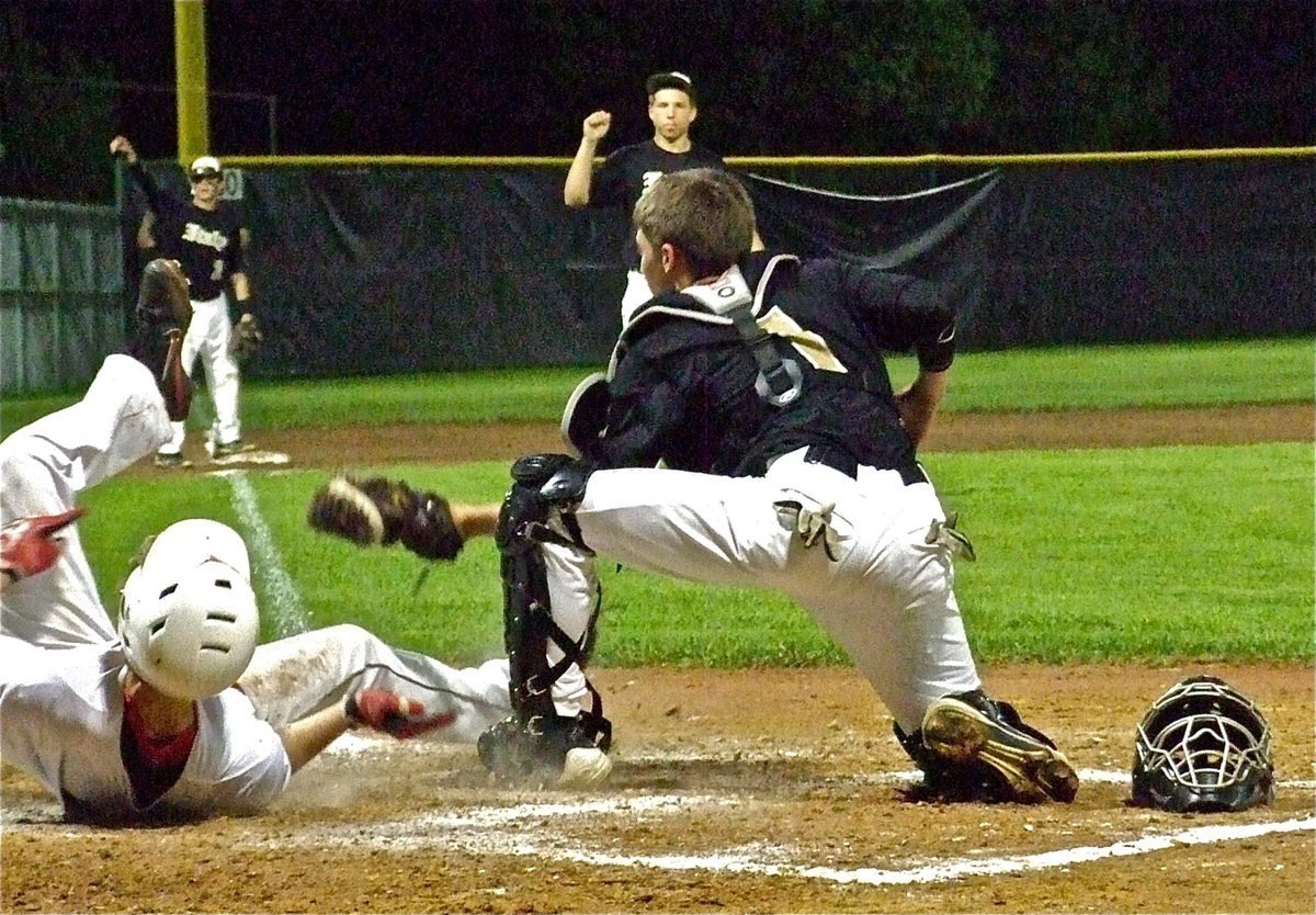 Image: Gladiator catcher, Ross Stiles(1) makes the tag at the plate for an out as Kyle Jackson(7) and Caden Jacinto(2) cheer their teammate’s effort.