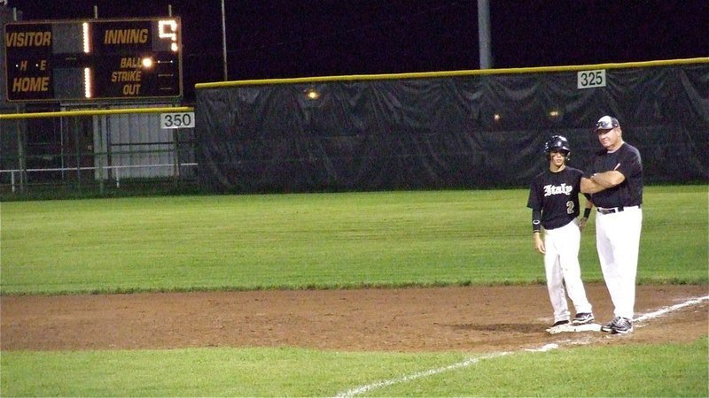 Image: Gladiator assistant coach, Randy Parks talks with Caden Jacinto(2) who hit a single to give Italy a chance in the top of the ninth-inning with the score tied, 1-1.