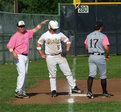 Image: Zain Byers(5) digs out a triple to the delight of Coach Ward, who is either congratulating his slugger or calling for a medic.