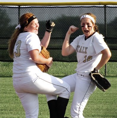 Image: Katie Byers(13) and Bailey Bumpus(18) create a bit of pre-game spirit during warmups.