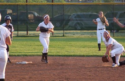 Image: Paige Westbrok(10) makes a diving play at second base and then flips the ball to Bailey Bumpus(18), covering second, for a double play with Madison Washington(2) backing things up in centerfield.