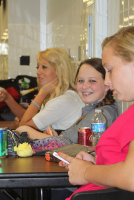 Image: Megan Richards chats with friends between contests, while Maddie Pittmon grins big for the camera all the while Jaclynn Lewis checks out current events on her iPhone. 