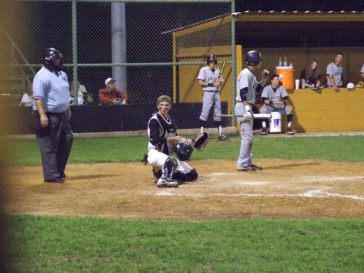 Image: Ross Stiles checks Coach Ward for any pitching details.