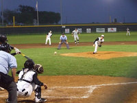 Image: Caden Jacinto, on the mound, sends a fast ball over home plate on Monday night.