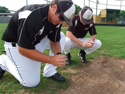 Image: Kevin Roldan and Cody Boyd scuff up the game balls.