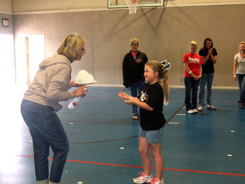 Image: “Is this big enough? You want me to make it bigger?” Mrs. Janek asks the last pie throwing Tiger, Haley Mathers.