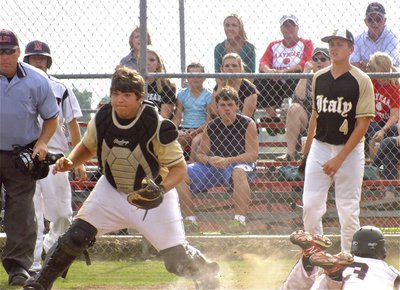 Image: Italy catcher, Kevin Roldan, tries to get the pass and tag a Maypearl runner sliding into home while teammate, Bailey Walton(4), backs up the play.
