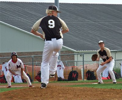 Image: Cody Boyd(9), prepares to pitch as first baseman, Bailey Walton(4), tries to keep a Panther runner close to the bag.