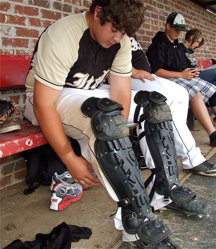 Image: Kevin Roldan gears up for his first action at catcher this season for the JV Gladiators.