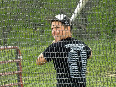 Image: Gladiator senior, Kyle Jackson, warming up in the batting cage.