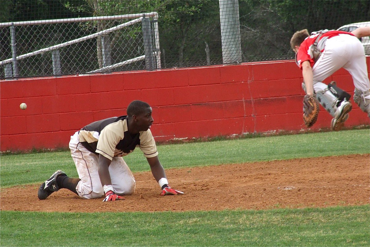 Image: Italy’s, Marvin Cox, slides home for a run against the Tigers.