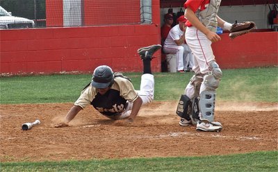 Image: John Hughes, slides across home plate for his first of two runs in the second game of the double-header between Glen Rose and Italy’s JV teams.