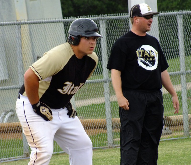 Image: Coach Ward, communicates with his base runners as, Kevin Roldan, leads off at third.