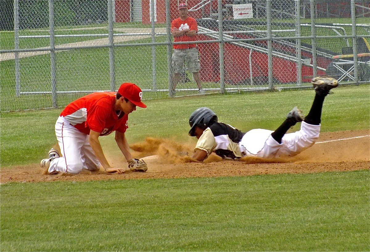 Image: John Hughes, slides safely into third base to wow Italy’s fans.