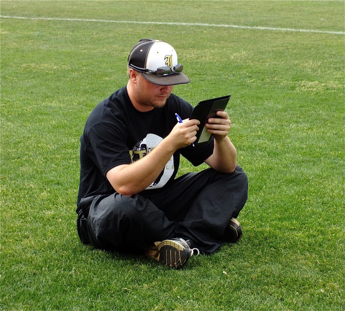 Image: Italy Baseball head coach, Josh Ward, adjusts the batting order for the second game of a double-header between the Italy JV Gladiators and the Glen Rose JV Tigers.