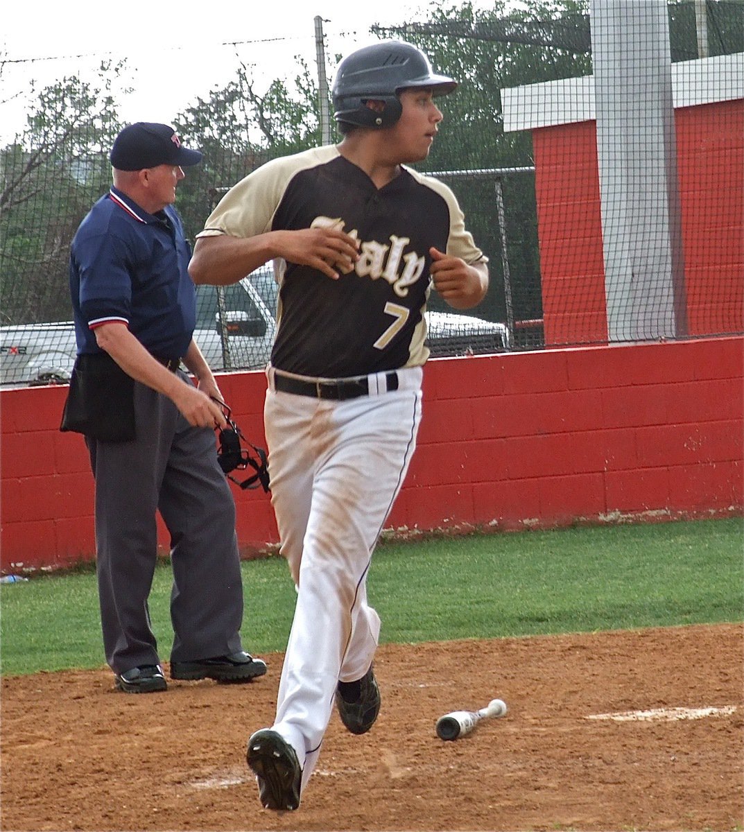 Image: JV Gladiator, Omar Estrada(7), crosses home plate for an Italy run.