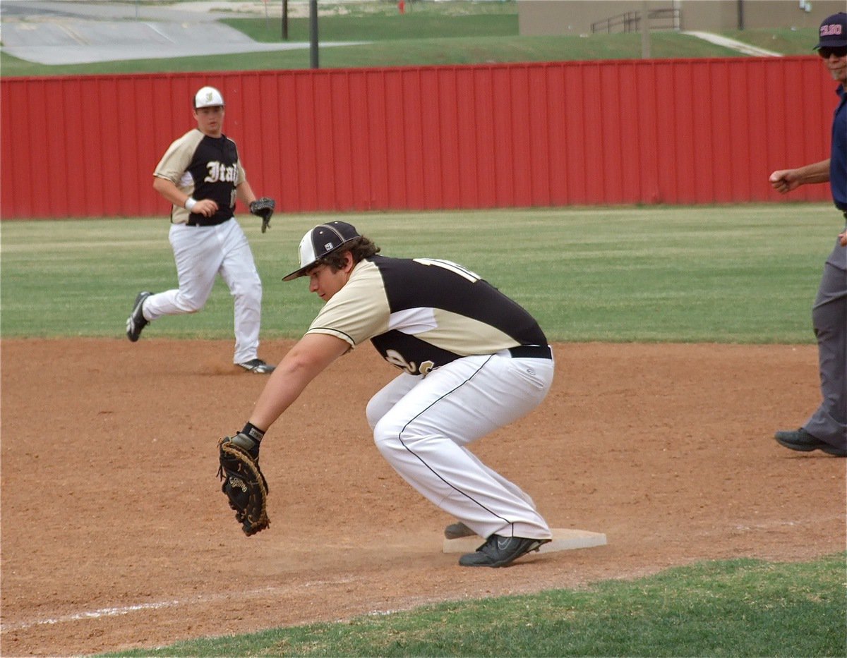 Image: Kevin Roldan(16), secures the catch for an out at first base.