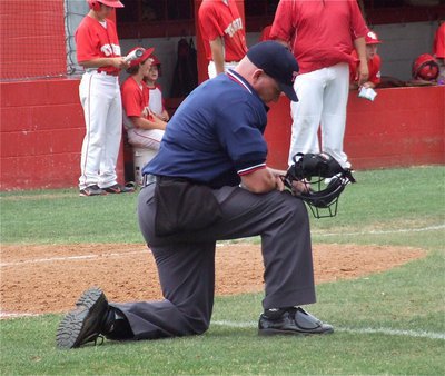 Image: Two games is almost too much for the plate umpire as both schools battle for 13-innings during a double-header on Saturday.