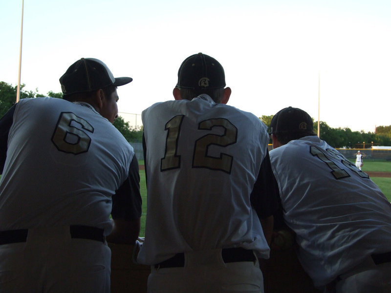 Image: Omar Estrada, Justin Wood and John Byers hang together in the dug out.