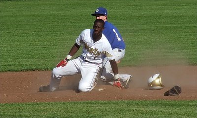 Image: Italy’s, Marvin Cox(1), slides safely into second base against Whitney.