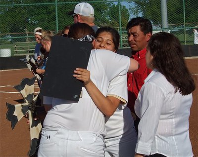 Image: Alma Suaste, receives a good luck hugs from teammates.