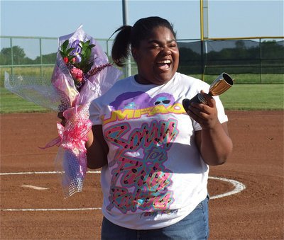 Image: Sa’Kendra Norwood, the home announcer for the Lady Gladiators, is ecstatic upon receiving flowers and a trophy for her support.