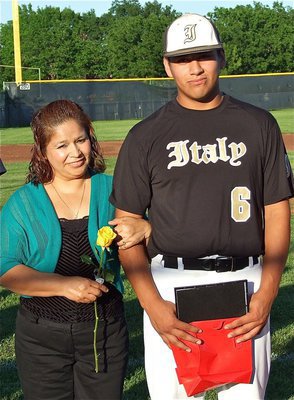 Image: Senior Gladiator, Omar Estrada(6), is honored before Italy’s game against Whitney and is escorted by his mother, Maria Estrada.