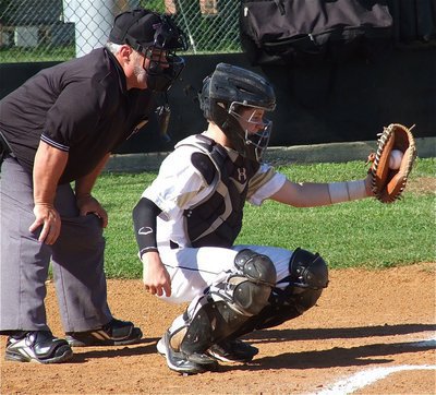 Image: Catcher, John Escamilla, displays the ball for the umpire to get a better look at it.