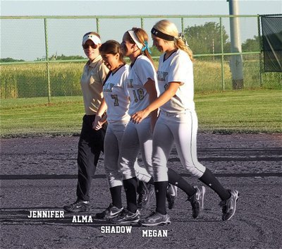 Image: Last Walk: Lady Gladiator head coach, Jennifer Reeves, escorts her senior players, Alma Suaste, Bailey Bumpus and Megan Richards during their last walk on their home field as the memories wash over them.