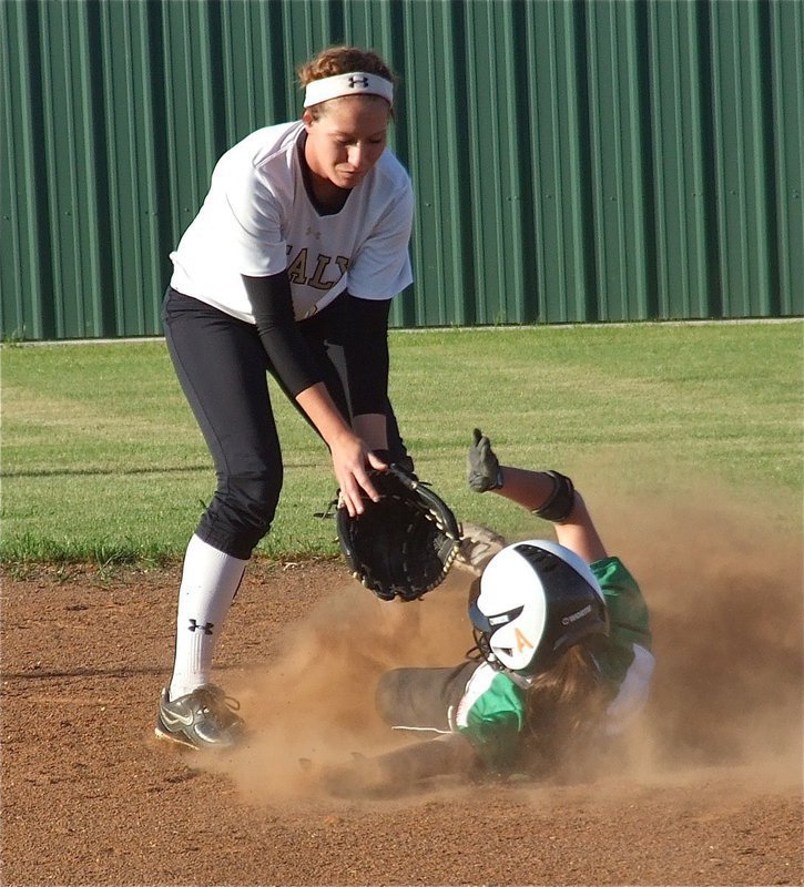 Image: Sliding in cleat high, Clifton’s base runner disrupts a chance for the tag from, Lady Gladiator shortstop, Bailey Bumpus(18).