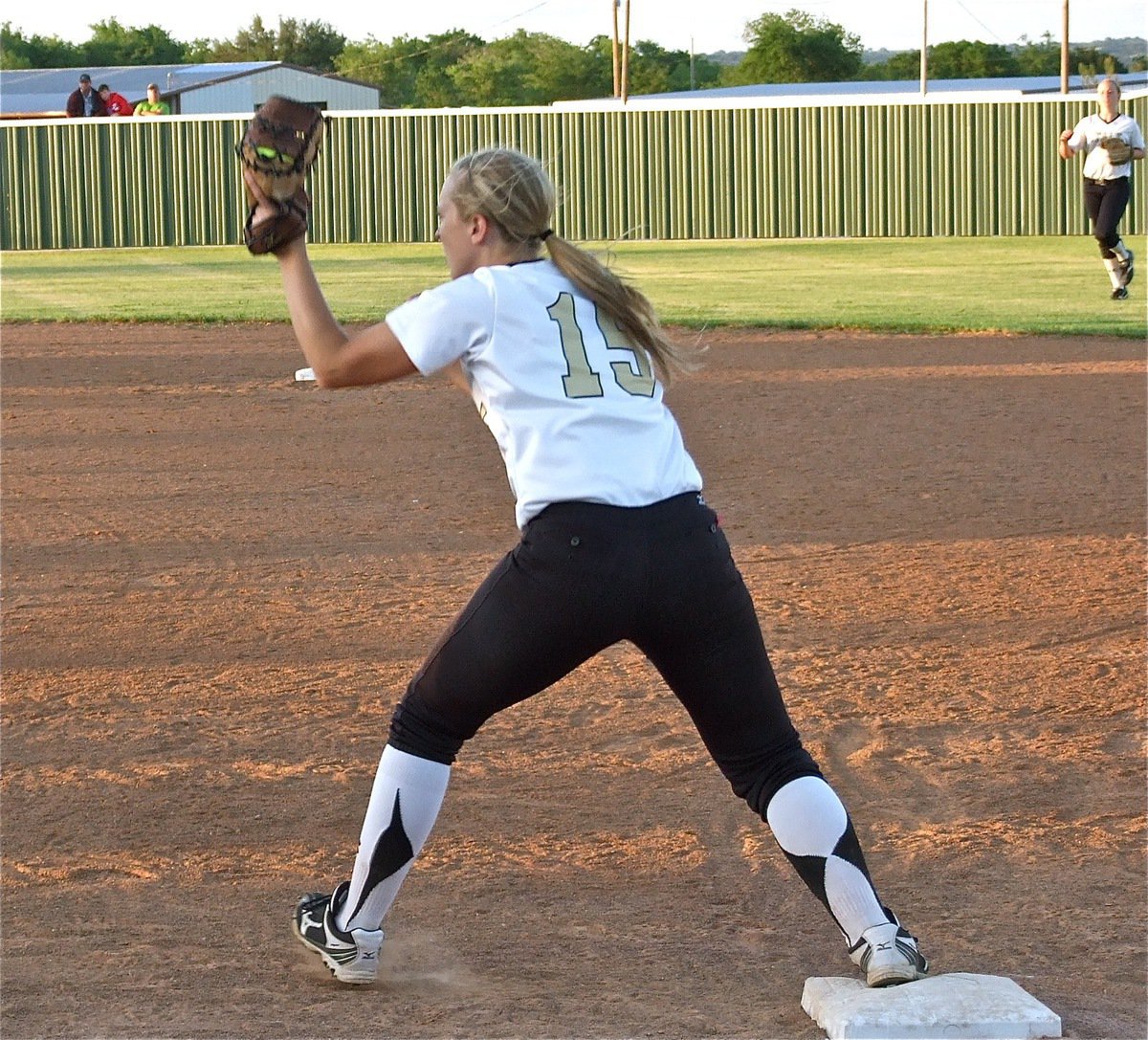 Image: Jaclynn Lewis(15) makes the catch at first base for an out.