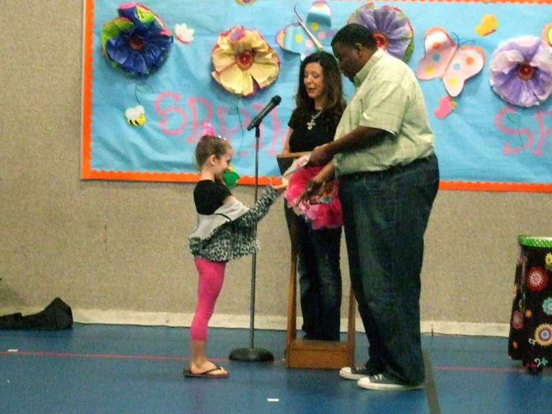 Image: This kindergartner proudly accepts her award.