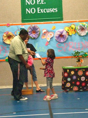 Image: This first grader is happy to get her award.