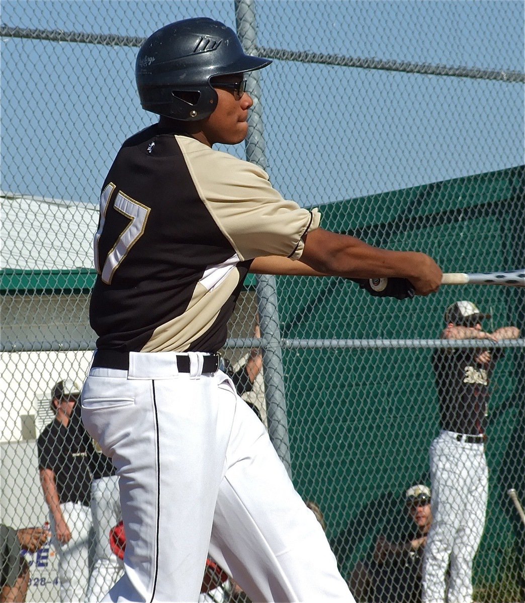 Image: Taking a cut at the cowhide is JV Gladiator, John “Squirt” Hughes.