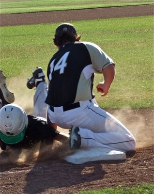 Image: JV Gladiator third baseman, Kyle Fortenberry(14), makes the tag and gets the out against a sliding Rio runner.