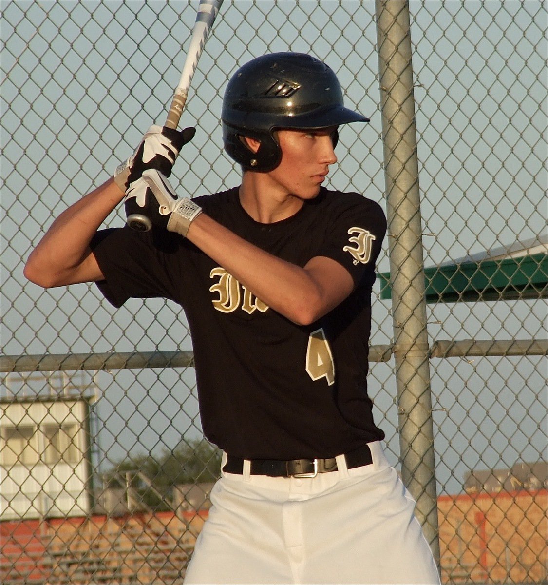 Image: Senior Gladiator, Alex DeMoss(4), eyes Rio’s pitcher.