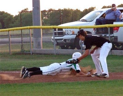 Image: Cole Hopkins(9) tries to tag out an Eagle base runner at first.
