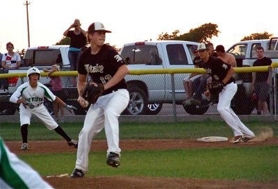 Image: Pitcher, Justin Buchanan(13) gets himself out of trouble while Cole Hopkins(9) gets back into defensive position.