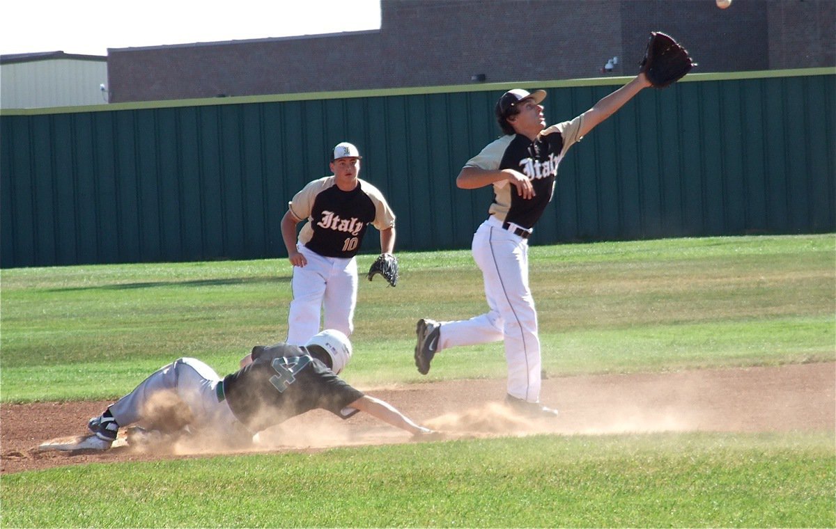 Image: Busy day at second: Chace McGinnis(2) stretches for the ball with Zain Byers(10) backing him up.