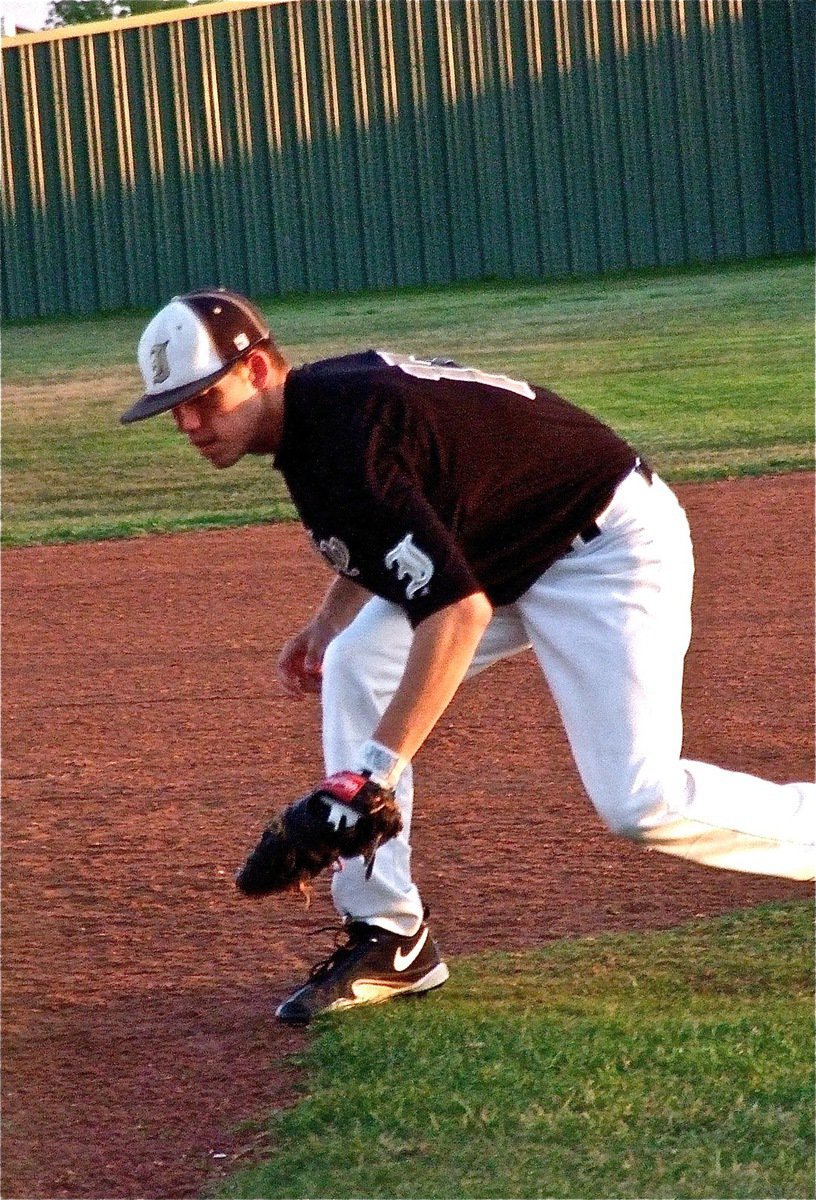 Image: Senior Gladiator Brandon Souder(17) snags a grounder at third base.