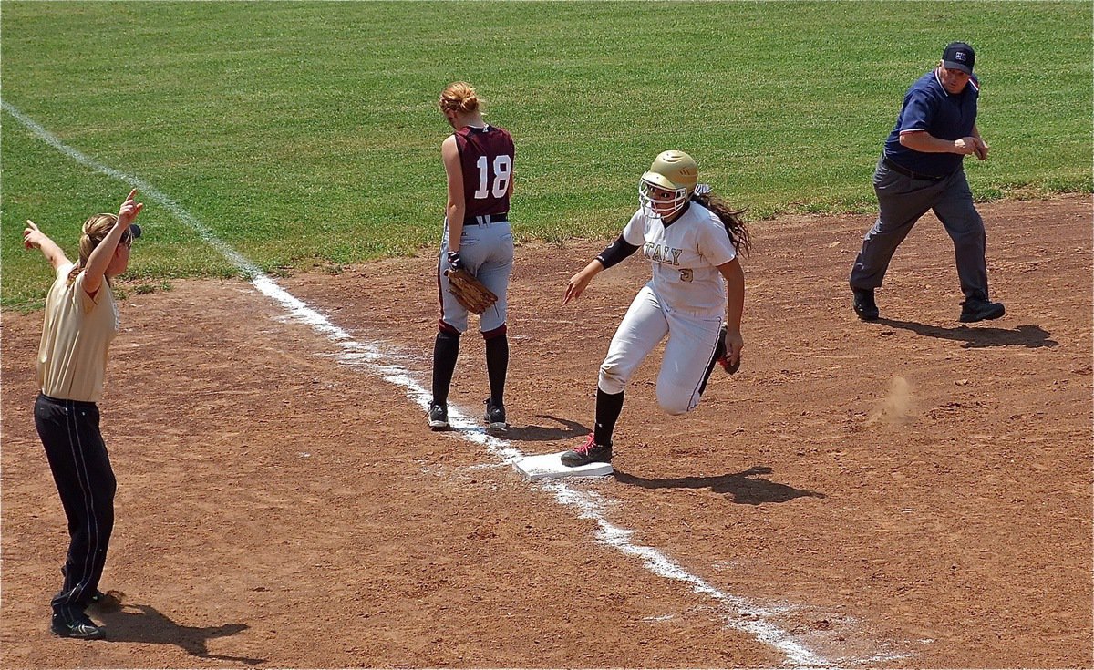 Image: Coach Reeves directs, Alyssa Richards(9,) to keep running towards home plate.