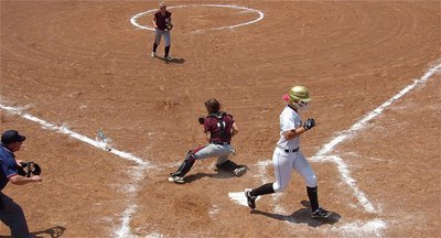 Image: Jaclynn Lewis(15) beats the throw home and crosses home plate for another Italy run.
