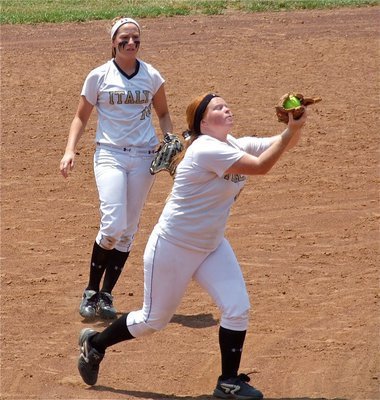 Image: Katie Byers(13) uses the force to haul in a popup at third base as Bailey Bumpus(18) backs her up.